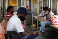 FILE PHOTO: People ride the subway in New York City