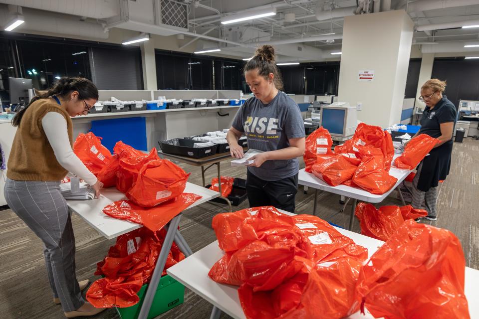 Staff and volunteers receive electronically-stored ballots and other polling material dropped at the Mecklenburg County Board of Elections after polls close during Super Tuesday on March 5, 2024 in Charlotte, United States.