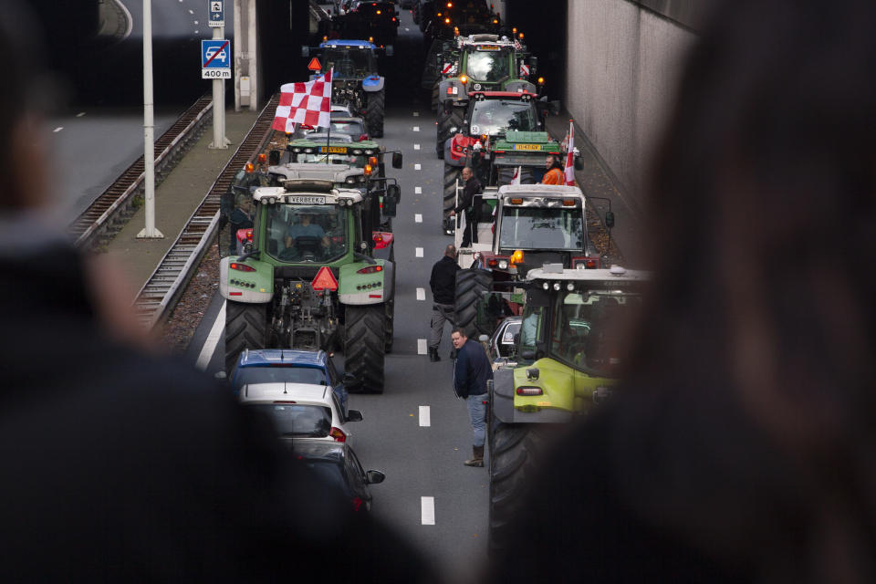 Protesting farmers block a main road leading to the center of The Hague, Netherlands, Wednesday, Oct. 16, 2019. Thousands of Dutch farmers protest over the Netherlands efforts to drastically reduce emissions of greenhouse gases. Among the farmers' demands are that the government does not further reduce the number of animals they can keep. (AP Photo/Peter Dejong)