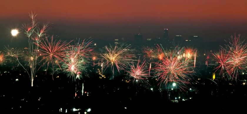 Downtown Los Angeles can be seen in the background through haze and smoke with Fourth of July fireworks going off in various neighborhoods, as seen from Whittier looking west on this 21-second single exposure on Monday, July 4, 2022.