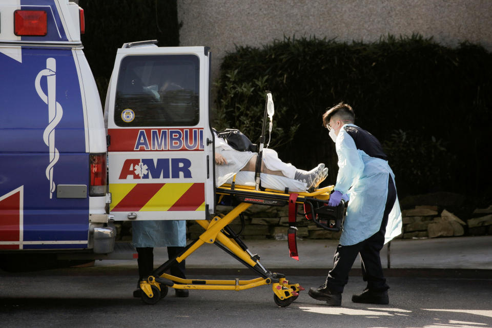 Medics load a person into an ambulance the Life Care Center of Kirkland, the long-term care facility linked to several confirmed coronavirus cases in the state, in Kirkland, Washington, U.S. March 4, 2020.  REUTERS/David Ryder     TPX IMAGES OF THE DAY