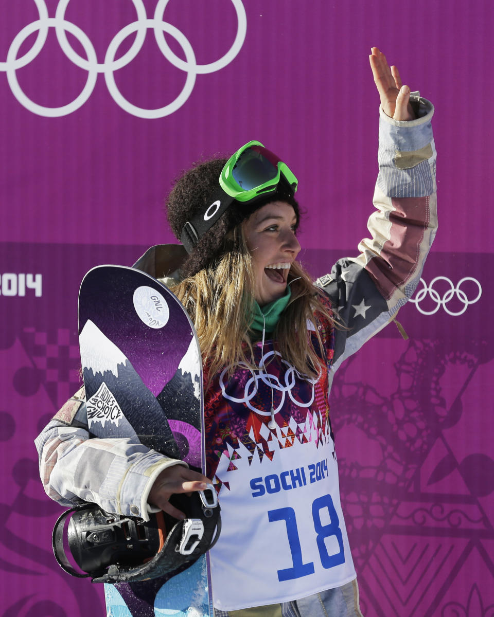 United States' Jamie Anderson waves to supporters after a run in the women's snowboard slopestyle qualifying at the Rosa Khutor Extreme Park ahead of the 2014 Winter Olympics, Thursday, Feb. 6, 2014, in Krasnaya Polyana, Russia. (AP Photo/Andy Wong)