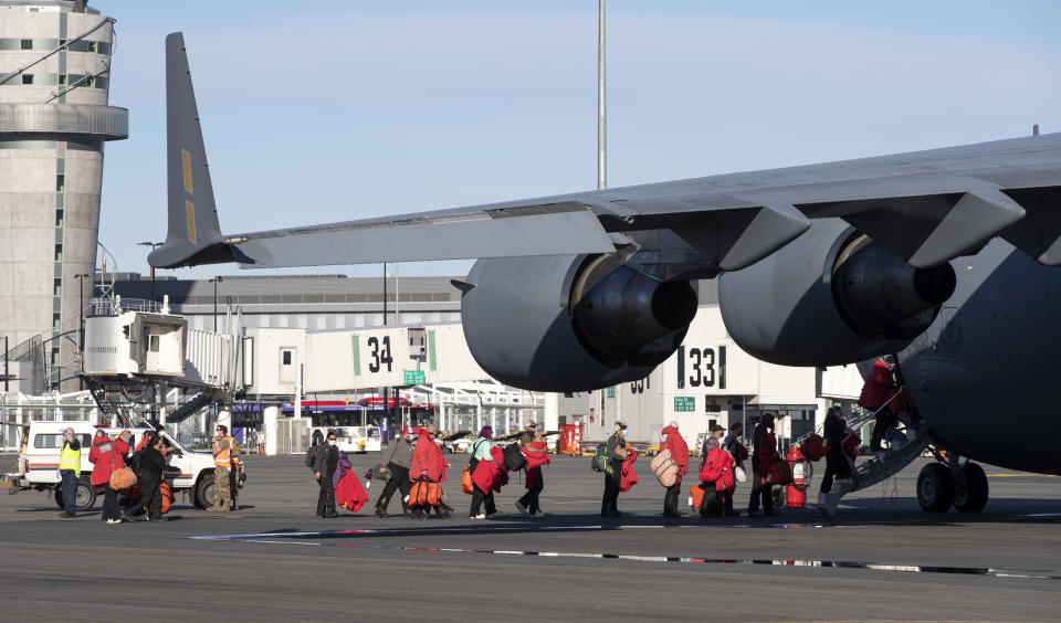 Staff board a U.S. Air Force C-17 as they prepare to take the season's first flight to McMurdo Station in Antarctica from Christchurch Airport, New Zealand, Monday, Sept. 14, 2020. The first U.S. flight into Antarctica following months of winter darkness left from New Zealand Monday with crews extra vigilant about keeping out the coronavirus. (AP Photo/Mark Baker)