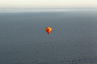 IN FLIGHT - APRIL 07: A hot air balloon which departed from Lydden Hill race circuit near Canterbury takes part in a mass crossing of the Channel on April 7, 2011 in Flight over the English Channel. 51 balloonists of various nationalities from across Europe took off from Kent making for Calais, France at about 7am. It is the first time a Guinness World Record bid has been made for "the largest group of hot air balloons to make the Channel crossing". (Photo by Oli Scarff/Getty Images)