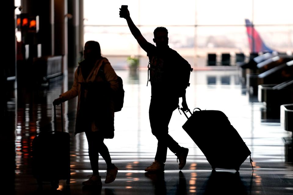 People pass through Salt Lake City International Airport on Jan. 11, 2023, in Salt Lake City. (AP Photo/Rick Bowmer, File)