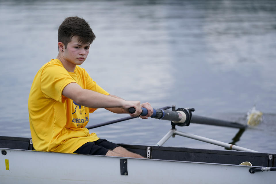 Callum Bradford rows during a club team practice at Jordan Lake, Friday, Oct. 6, 2023, in Apex, N.C. Bradford, a transgender teen from Chapel Hill needed mental health care after overdosing on prescription drugs. He was about to be transferred to another hospital due to a significant bed shortage. A North Carolina hospital network is referring transgender psychiatric patients to treatment facilities that do not align with their gender identities. Though UNC Hospitals policy discourages the practice, administrators say a massive bed shortage is forcing them to make tough decisions. (AP Photo/Erik Verduzco)