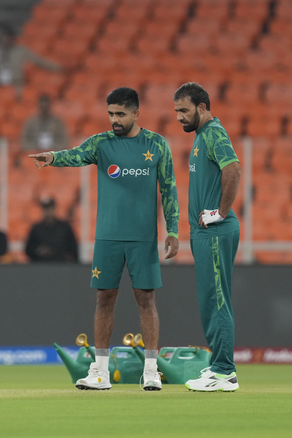 Pakistan's captain Babar Azam, left, and Iftikhar Ahmed check the pitch ahead of their ICC Cricket World Cup match against India in Ahmedabad, India, Thursday, Oct. 12, 2023. India and Pakistan will play their World Cup match in Ahmedabad on Saturday. (AP Photo/Ajit Solanki)