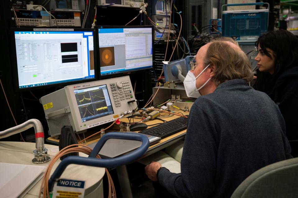 Senior scientist Walter Hartung, left, mentors Sara Zeidan, an undergrad research assistant with the Accelerator Science and Engineering Traineeship (ASET), as they work on a plasma cleaning of a half wave cavity at the Facility for Rare Isotope Beams (FRIB) at Michigan State University in East Lansing on Tuesday, Aug. 1, 2023.