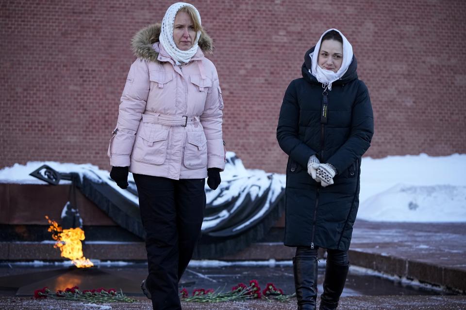 FILE - Wives of Russian soldiers mobilized for Ukraine in 2022 walk after laying flowers at the Unknown Soldier's Tomb at the Kremlin wall in Moscow, Russia, on Saturday, Jan. 13, 2024. Wives of some soldiers demanded their discharge from service in a challenge to the Kremlin. (AP Photo, File)