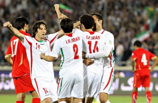 Iranian players celebrate after scoring a goal against Bahrain during their 2014 World Cup Asian zone qualifying football match at the Azadi Stadium in Tehran. Iran won 6-0