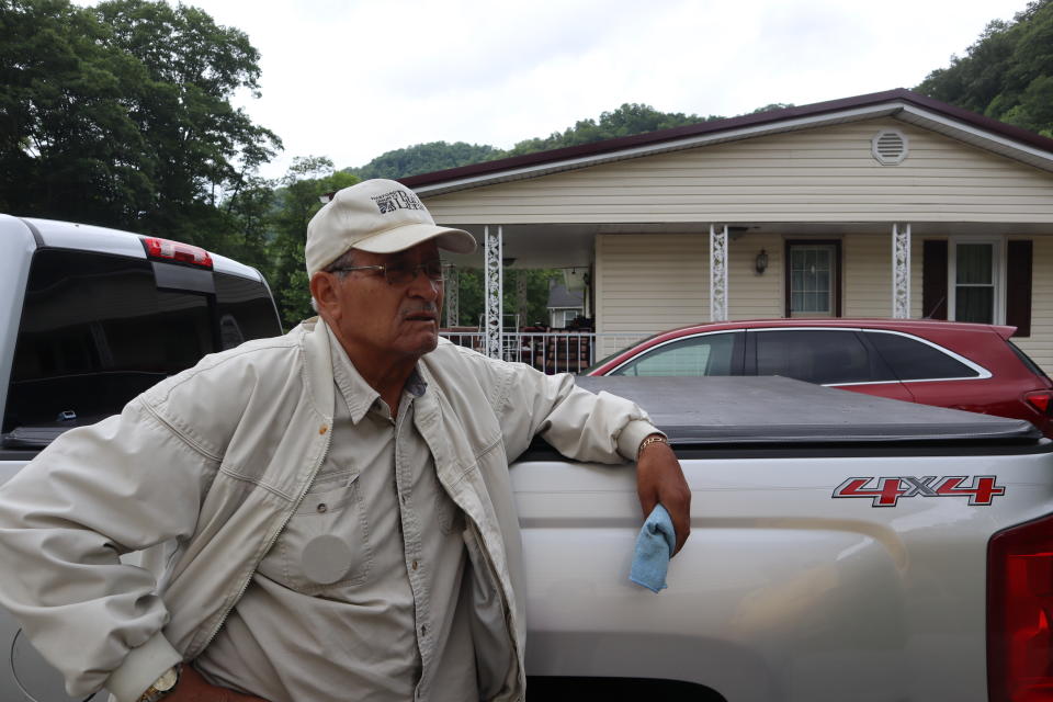 Mike Hairston, a fourth-generation coal miner, speaks in his driveway about the unmarked gravesite down the road from his home where more than 80 West Virginia coal miners who died in a 1912 mining disaster are buried in unmarked graves in Havaco, W.Va., on June 7, 2022. (AP Photo/Leah Willingham)