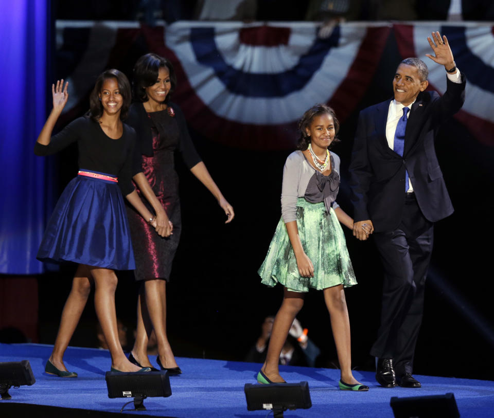 President Barack Obama waves as he walks on stage with first lady Michelle Obama and daughters Malia and Sasha at his election night party Wednesday, Nov. 7, 2012, in Chicago. President Obama defeated Republican challenger former Massachusetts Gov. Mitt Romney. (AP Photo/Chris Carlson)