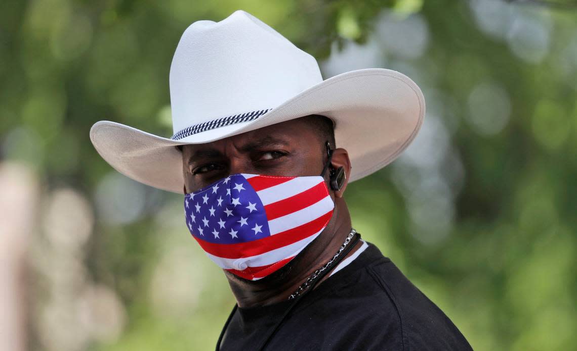 Amid concerns of the spread of the novel coronavirus, Stern Ferguson wears a mask during a drive through Juneteenth 2020 celebration in Dallas, Friday, June 19, 2020. Juneteenth marks the day in 1865 when federal troops arrived in Galveston, Texas to take control of the state and ensure all enslaved people be freed. (AP Photo/LM Otero)