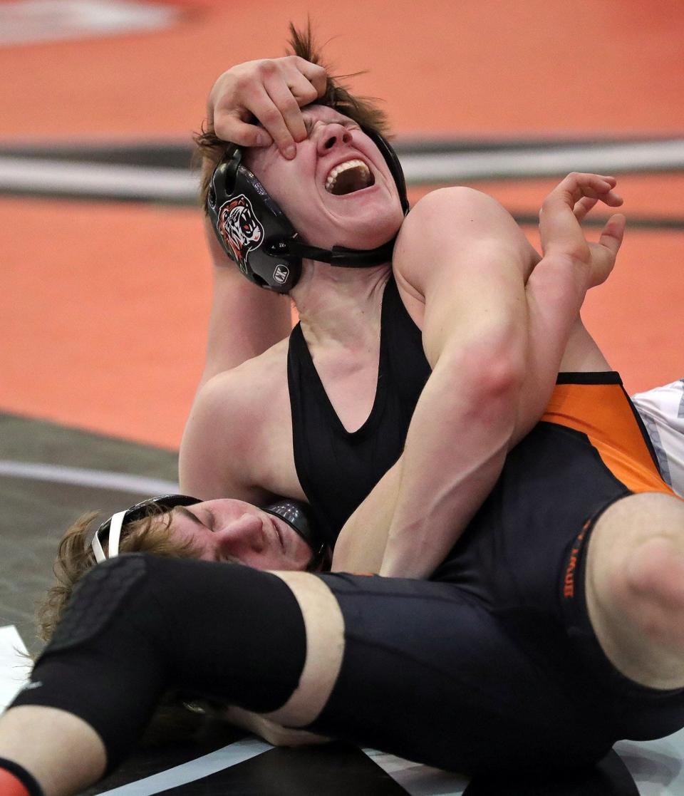 Aurora's Bo DiJulius, bottom, gouges the eye of Howland's Carter Mock to be disqualified from the Division II district tournament during their 144 pound quarterfinal match at Perry High School, Friday, March 4, 2022, in Perry, Ohio. [Jeff Lange/Beacon Journal]