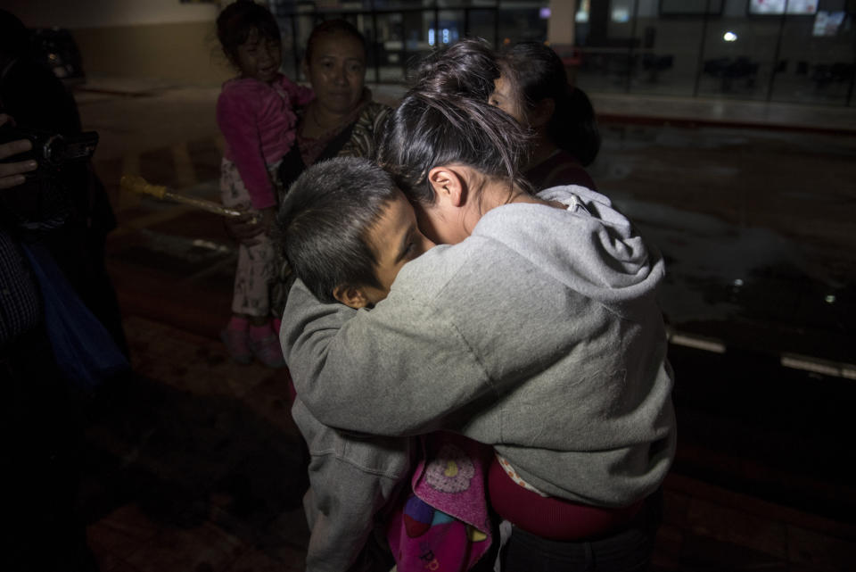 Anthony David Tovar Ortiz, a la izquierda, es abrazado por una familiar después de llegar al aeropuerto La Aurora en la Ciudad de Guatemala, el martes 14 de agosto de 2018. El niño de 8 años quedó en un albergue para niños migrantes en Houston después de que su madre fuera deportada en junio bajo la política de cero tolerancia del gobierno del presidente Donald Trump. (AP Foto / Oliver de Ros)