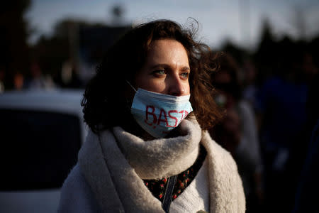 A nurse with a face mask reading "enough" is seen during a protest march in Lisbon, Portugal, March 8, 2019. REUTERS/Pedro Nunes