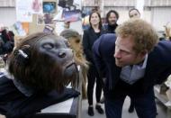 Britain's Prince Harry takes a closer look at a robotic mask during a tour of the Star Wars sets at Pinewood studios in Iver Heath, west of London, Britain on April 19, 2016. REUTERS/Adrian Dennis/Pool