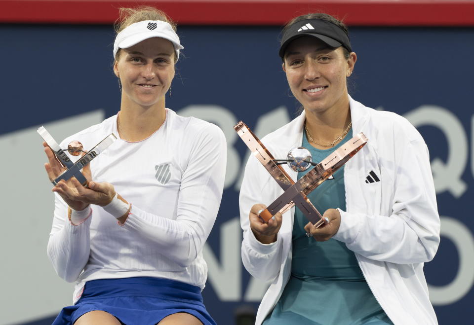Jessica Pegula, right, of the United States, and Liudmila Samsonova, left, of Russia, hold their trophies following the final of the women's National Bank Open tennis tournament in Montreal, Sunday, Aug. 13, 2023. (Christinne Muschi/The Canadian Press via AP)
