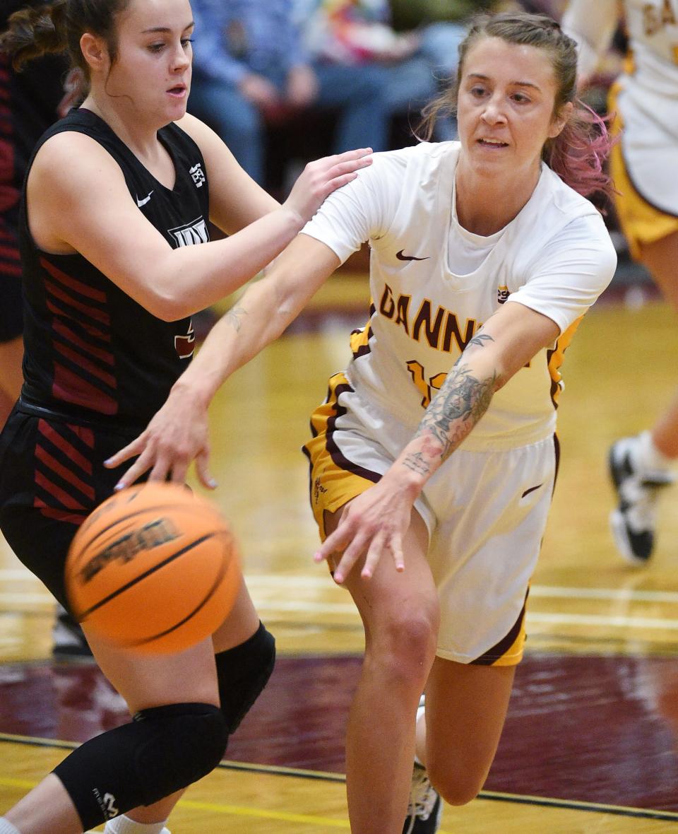 Gannon's Emma Wright, right, passes to a teammate underneath the basket against IUP at Gannon's Highmark Events Center in Erie on Jan. 11. The Golden Knights host the PSAC Final Four this weekend.