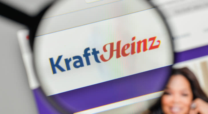 A magnifying glass zooms in on the Kraft Heinz (KHC) website.