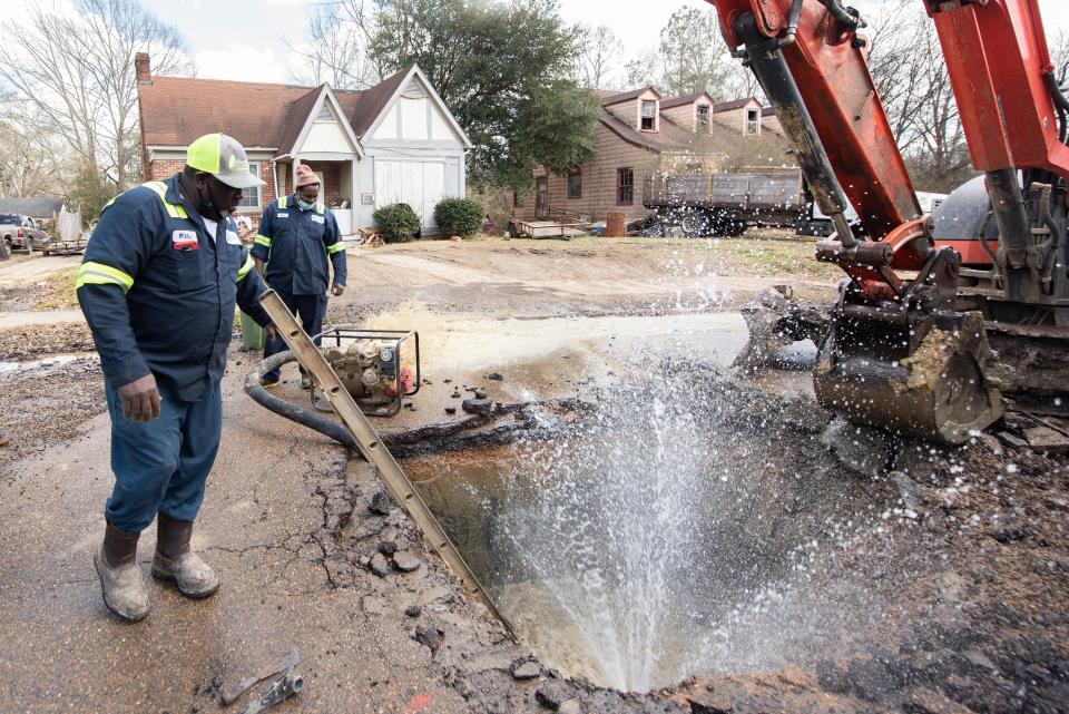 Water shoots out of a broken six-inch water main north of the intersection of Claiborne Avenue and St. Charles Street, where the W-10 crew from the city of Jackson Water Maintenance Department pumps out the water so they can fix the break Friday, Feb. 26, 2021. Water Maintenance Department crews are working throughout the city to fix breaks to help get water restored to residents after the recent winter storms that hit the area.