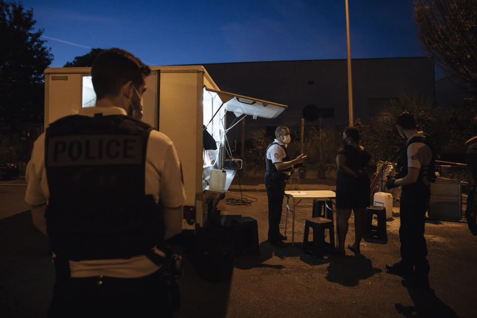 Police major Nicolas, center, talks to a street vendor to check authorizations in the Paris suburb of Garges-les-Gonesse, Tuesday, June, 15, 2021. He is a veteran patrolman in the Paris suburb of Sarcelles and its surrounding towns that are hotspots for crime. He is among the officers who say violence is getting worse. (AP Photo/Lewis Joly)