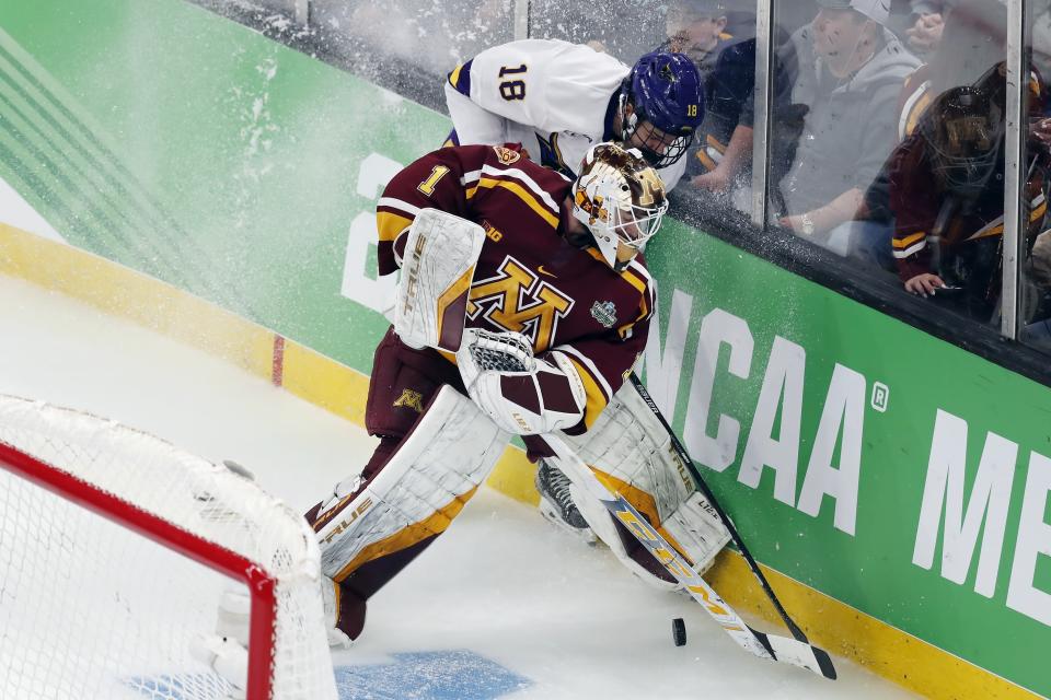 Minnesota State's Ondrej Pavel (18) and Minnesota goalie Justen Close (1) compete for the puck during the first period of an NCAA men's Frozen Four men's hockey semifinal Thursday, April 7, 2022, in Boston. (AP Photo/Michael Dwyer)