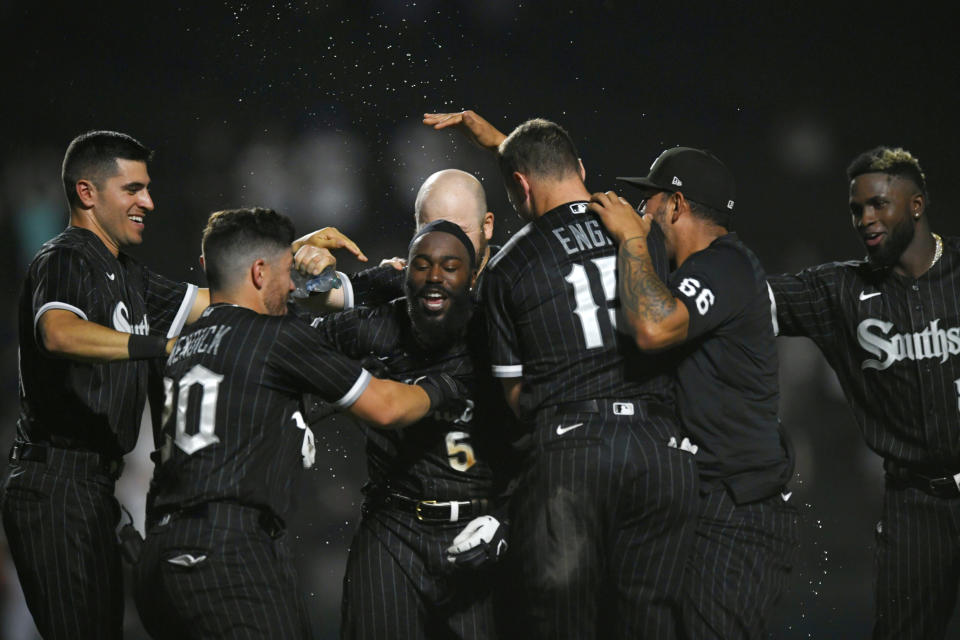 Chicago White Sox's Josh Harrison (5) celebrates with teammates after hitting a walk-off RBI single to defeat the Toronto Blue Jays 7-6 in twelve innings of a baseball game Tuesday, June 21, 2022, in Chicago. (AP Photo/Paul Beaty)