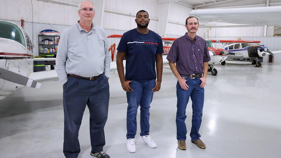 Dr. Paul Clark poses at Amarillo's River Falls Airport with students Brandon Nelson, center, and Branson Cruse.