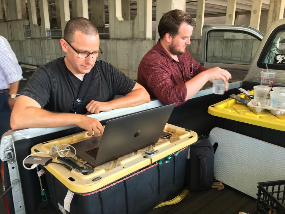 Capital Gazette reporter Chase Cook (R) and photographer Joshua McKerrow (L) work on the next days newspaper while awaiting news from their colleagues in Annapolis, Maryland, June 28, 2018.