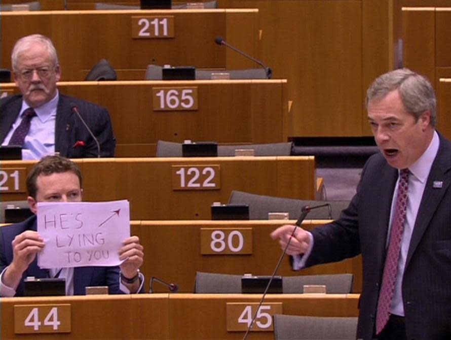 Labour MEP Seb Dance holds up a sign saying 'HE'S LYING TO YOU' as Nigel Farage praises Donald Trump in the European Parliament: BBC