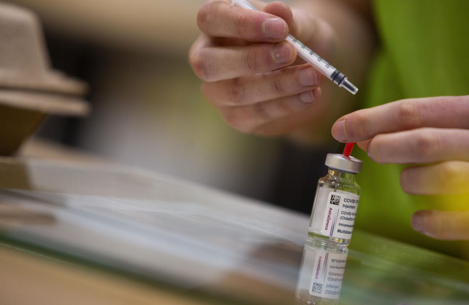 A pharmacist prepares to fill a syringe with the AstraZeneca COVID-19 vaccine at the Vaccine Village in Antwerp, Belgium on Tuesday, March 16, 2021. Belgium on Tuesday reaffirmed its support to AstraZeneca vaccines and said it will keep using it in its current vaccination campaign, amid raising concerns over its side effects and with growing number of EU countries deciding to protectively stop using it. (AP Photo/Virginia Mayo)