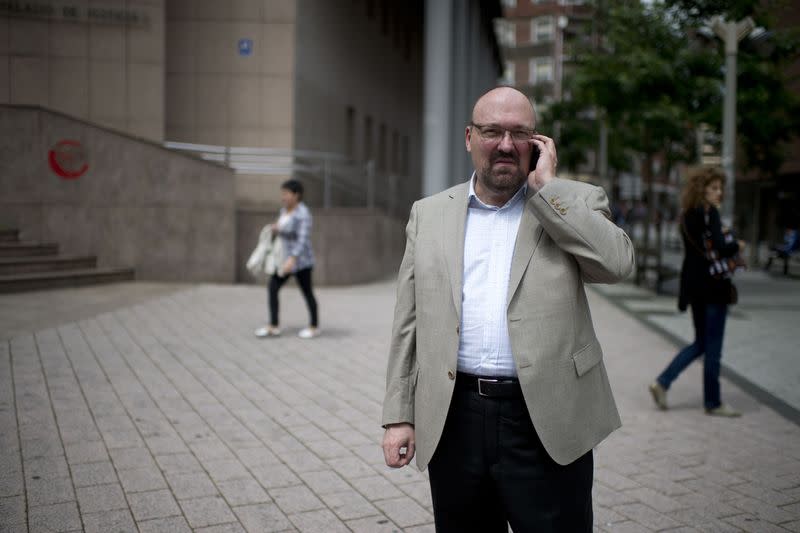 Caligraphy expert witness Mario Costeja Gonzalez speaks on his mobile phone outside a court in Barakaldo June 25, 2013. REUTERS/Vincent West