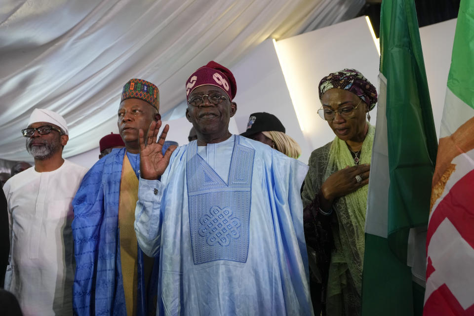 FILE- Bola Tinubu of the All Progressives Congress, center, accompanied by his wife Oluremi Tinubu, right, leaves the party's campaign headquarters after winning the presidential elections in Abuja, Nigeria, Wednesday, March 1, 2023. The growing security crisis presents a huge challenge for Nigeria's incoming President, Bola Tinubu, who rose to power on promises of improving the living conditions of communities whose lives have been impacted by the violence and addressing the root causes of the crisis by providing jobs and ensuring justice. But if the violence isn't reigned in, analysts say it could destabilise the country and drive more of its 216 million people further into poverty. (AP Photo/Ben Curtis, File)
