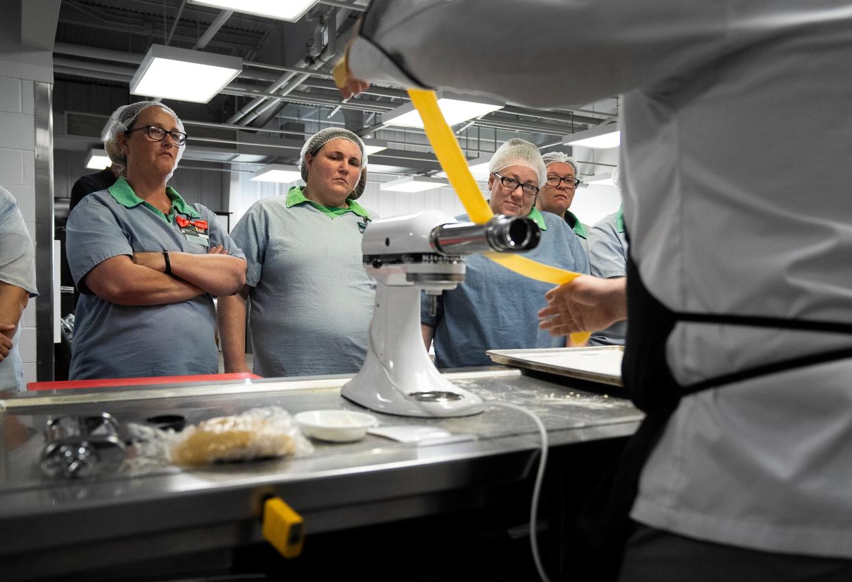 Chef Justin Thatcher, a culinary instructor, rolls fresh pasta dough as students watch during a cooking class through Sinclair Community College at the Ohio Reformatory for Women in Marysville.