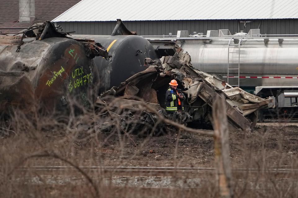 Feb 20, 2023; East Palestine, Ohio, USA;  Workers clean up the wreckage of the Norfolk Southern train derailment in East Palestine.  Mandatory Credit: Adam Cairns-The Columbus Dispatch