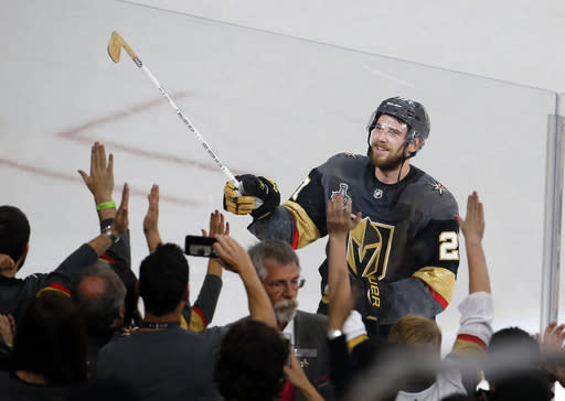 Vegas Golden Knights defenseman Shea Theodore gives his stick to fans after the Knights defeated the Washington Capitals 6-4 in Game 1 of the NHL hockey Stanley Cup Finals in Las Vegas. (AP Photo/Ross D. Franklin, File)