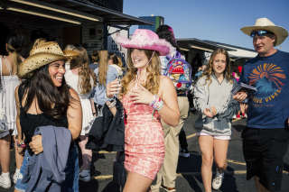 Des fans achètent des produits dérivés de Taylor Swift, devant le MetLife Stadium (New Jersey), avant le concert de la chanteuse, le 26 mai 2023.. PHOTO JUTHARAT PINYODOONYACHET/THE NEW YORK TIMES