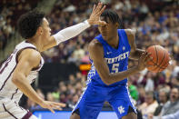 Kentucky guard Immanuel Quickley (5) looks to pass the ball as Texas A&M guard Andre Gordon (20) defends during the first half of an NCAA college basketball game Tuesday, Feb. 25, 2020, in College Station, Texas. (AP Photo/Sam Craft)