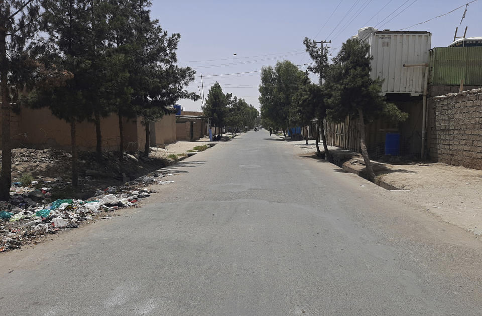 CORRECTS SPELLING OF TOWN TO LASHKAR GAH -- A street is mostly deserted during fighting between the Taliban and Afghan security forces in Lashkar Gah, Helmand province, southern Afghanistan, Tuesday, Aug. 3, 2021. The Taliban pressed on with their advances in Afghanistan's southern Helmand province on Tuesday as Afghan forces launched airstrikes to defend the provincial capital. (AP Photo/Abdul Khaliq)