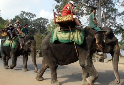 Foreign tourists are seen here riding on elephants near Cambodia's famed Angkor Wat temple in Siem Reap province. The Association of Southeast Asian Nations (ASEAN) is working on a plan that would open the region to foreign tourists in the same way Europe's unified visa system has streamlined travel