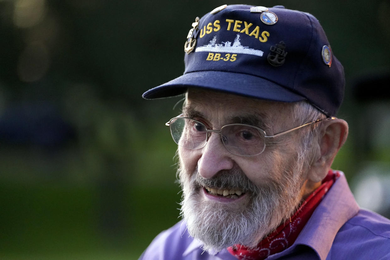 Julio Zaccagni, who served on the USS Texas from 1940 to 1942, watches as the battleship is moved, Wednesday, Aug. 31, 2022, in La Porte, Texas. The vessel, which was commissioned in 1914 and served in both World War I and World War II, is being towed down the Houston Ship Channel to a dry dock in Galveston where it will undergo an extensive $35 million repair. (AP Photo/David J. Phillip)