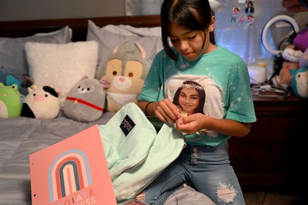 PHOTO: Wearing a shirt with her best friend Jackie Cazares, Caitlyne Gonzales prepares her backpack for the start of the new school year, Sept. 5, 2022, in Uvalde, Texas.  (The Washington Post via Getty Images)