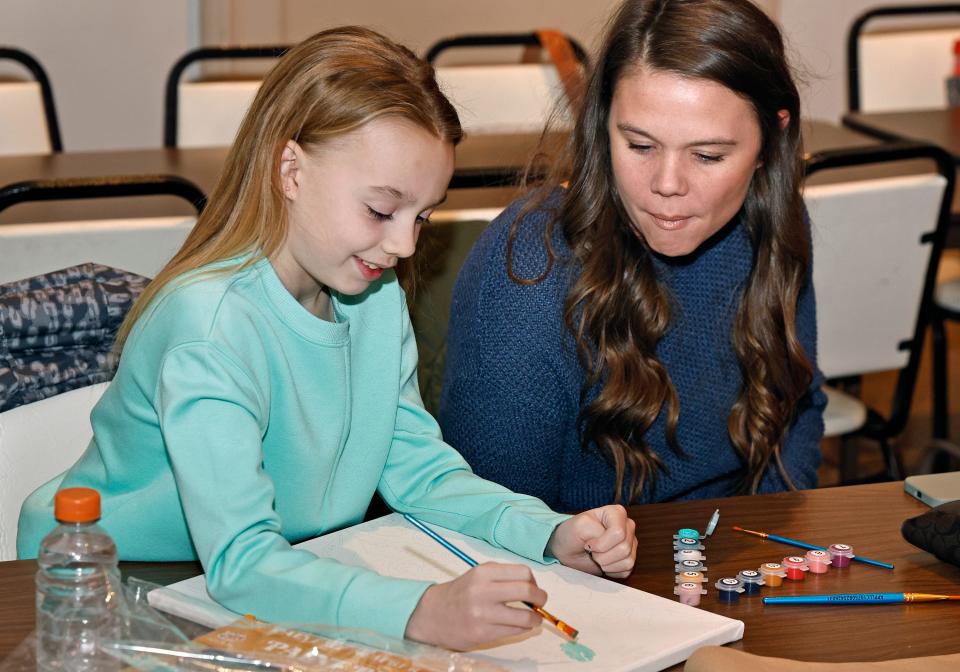 Bella Ripple, left, a third grader at Tecumseh Public Schools' Patterson Elementary School, works on a drawing Monday, Dec. 18, 2023, while her mother, Kyli Ripple, looks on.