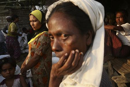 Rohingya people wait to receive their share of food aid from the World Food Program (WFP) at the Thae Chaung camp for internally displaced people in Sittwe, Rakhine state, April 24, 2014. REUTERS/Minzayar