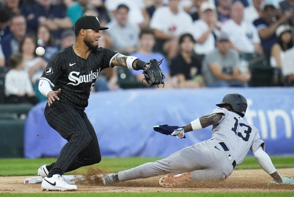 New York Yankees' Jazz Chisholm Jr., right, slide safe into third base as Chicago White Sox third baseman Lenyn Sosa misses the ball during the second inning of a baseball game Monday, Aug. 12, 2024, in Chicago. (AP Photo/Erin Hooley)