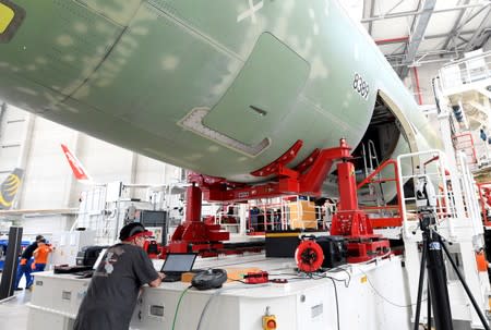 FILE PHOTO: An employee of Airbus works on a computer in an A320 production line at the Airbus plant in Hamburg