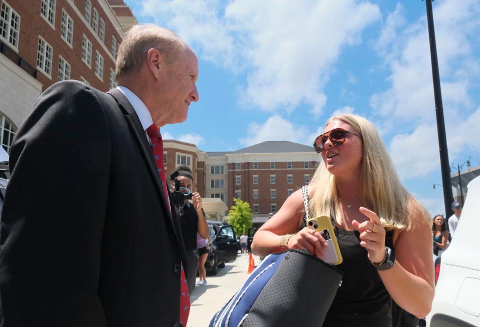 Incoming freshman women move into Tutwiler Hall on early move in day at the University of Alabama Wednesday, Aug. 9, 2023. University President Stuart Bell talks to incoming freshman Juliette Sandefur from Fairhope as she begins to unload her vehicle.