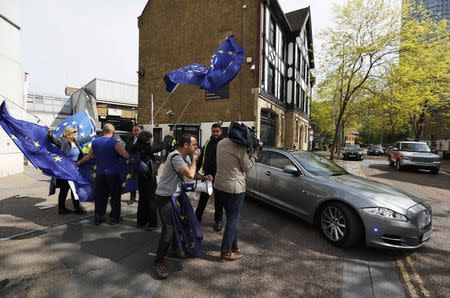 Pro-European Union demonstrators wave flags as Britain's Prime Minister Theresa May leaves ITV's studios, in London, April 30, 2017. REUTERS/Peter Nicholls
