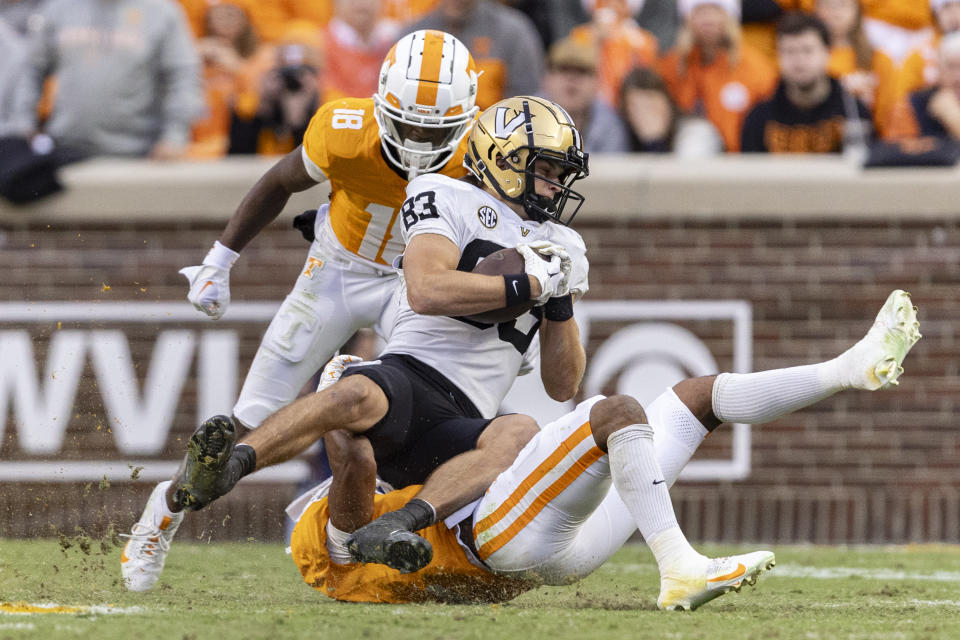 Vanderbilt wide receiver London Humphreys (83) is tackled by Tennessee defensive back Jaylen McCollough (2) during the first half of an NCAA college football game Saturday, Nov. 25, 2023, in Knoxville, Tenn. (AP Photo/Wade Payne)